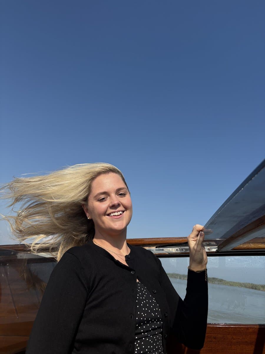 Lindsay on a boat with hair in the wind